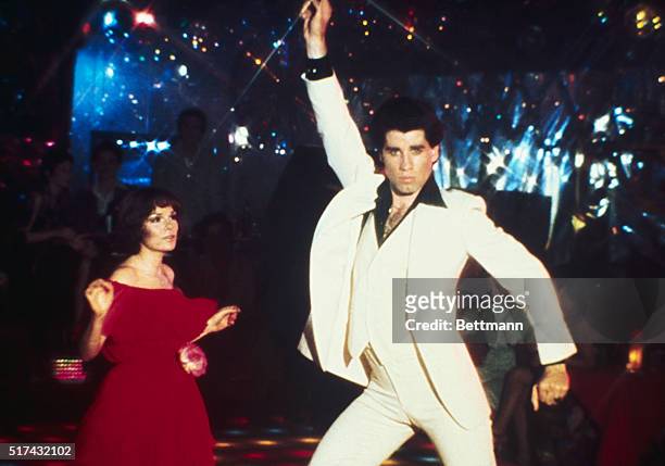 Actor John Travolta dancing with actress Karen Gorney in the movie "Saturday Night Fever".
