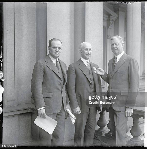 Photo shows Secretary of War Dwight Davis, , presenting Orville Wright with the Distinguished Flying Cross. The medal was Awarded by an Act of...