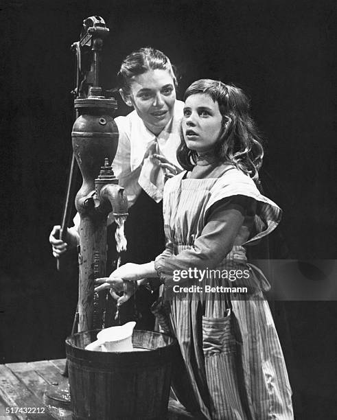 Anne Bancroft washes the hands of Patty Duke during a performance of the William Gibson Broadway play, 'The Miracle Worker', circa 1961. They are...