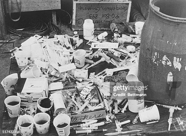 Pile of paper cups with cyanide-laced fruit punch, and a pile of hypodermic syringes, found at Jonestown by Guyanese officials.