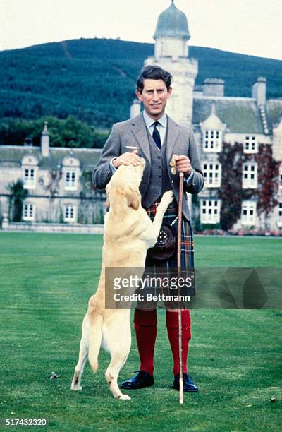 Britain's Prince Charles, the Prince of Wales, pets "Harvey," a retriever, during photo session 9/17 at Balmoral Castle, the Royal residence in...