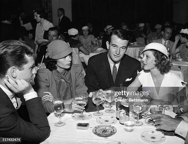 Los Angeles, CA-: John Wayne , well-known screen actor, dines with his bride, the former Josephine Saenz, daughter of Dr. Jose S. Saenz, the...