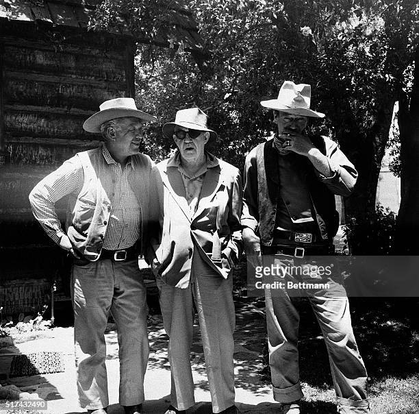 Photo shows, left to right, Ward Bond, Director John Ford and John Wayne. Undated photo.