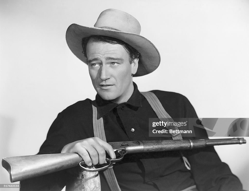 John Wayne Seated With Rifle