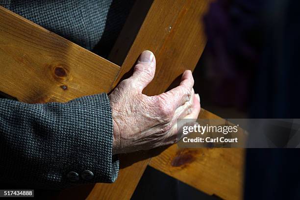 Worshipper holds a crucifix during a March of Witness through the town centre on March 25, 2016 in Sittingbourne, England. Christians around the...