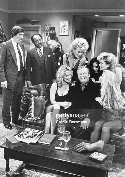 Paul Benedict, as Harry Bentley, and Sherman Hemsley, as George Jefferson, looks on in disbelief at the attention being lavished on Franklin Cover's...