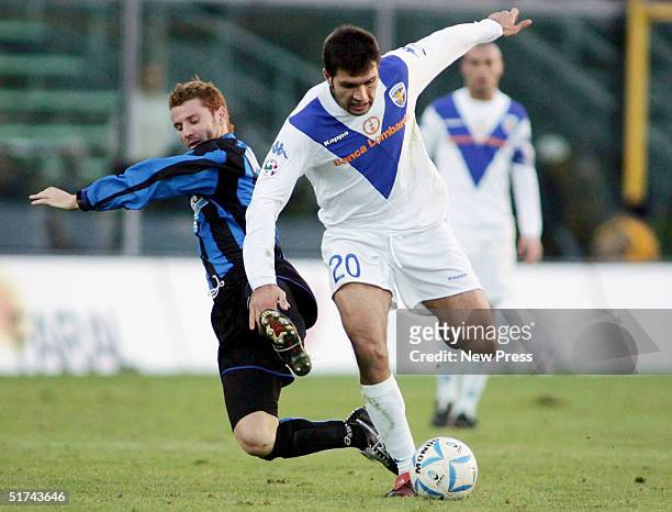 Brescia's Maurizzio Domizzi is tackled by Michele Marcolini of Atalanta during the Serie A match between Atalanta and Brescia on November 14, 2004 in...