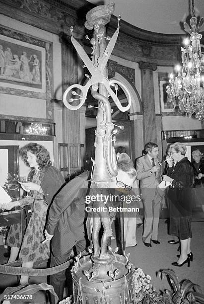 Spectator leans over to get a good look at Salvador Dali's largest surrealistic sculpture, titled Toreador Halucinogene Aux Cuillers, after it was...