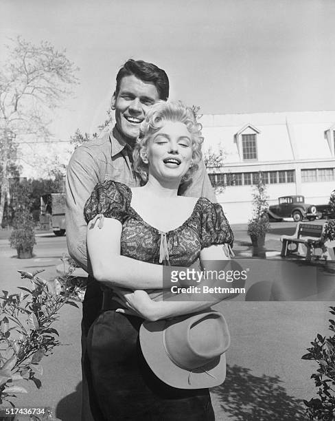 Imagine being paid for hugging Marilyn Monroe. But that's what's happening to Don Murray, who's bestowing a hug here for free. Murray has been given...