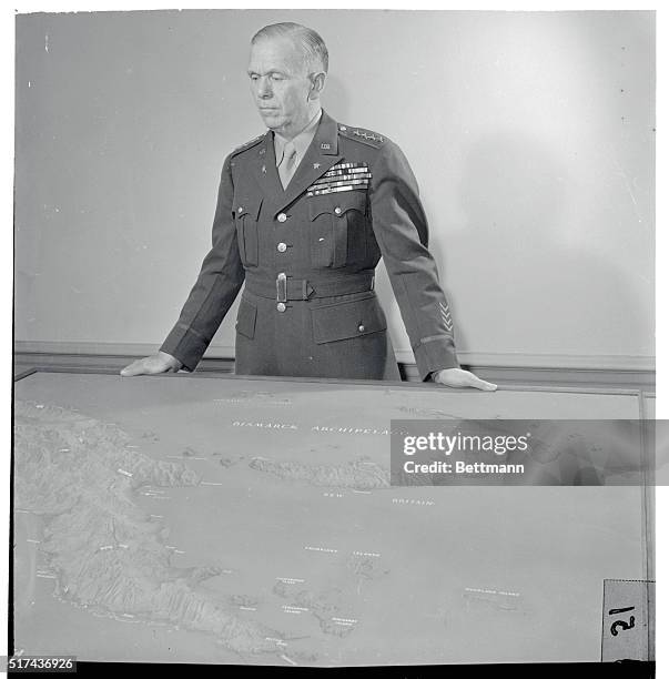Army Chief-Of-Staff, General George C. Marshall stands in front of a relief may of the New Britain area, after checking reports on the progress of...