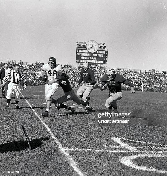 Otto Graham , star Northwestern back, is forced out of bounds as he returns a punt 6 yards in the second quarter of the Michigan game. The strong...