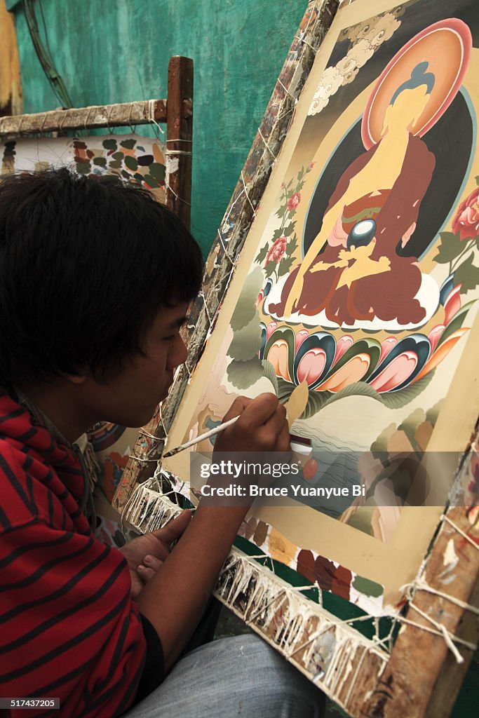 Craftsman making Thangka