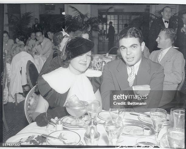 Miss Lois January and young David May, son of the famous department store magnate, are seen in this candid shot at the Biltmore Hotel.