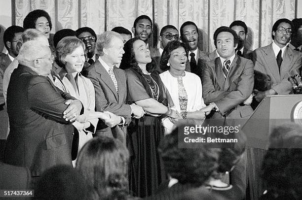 Washington. President Carter joins in singing, singing We Will Overcome with friends of Martin Luther King, Sr.; The first Lady; President Carter;...