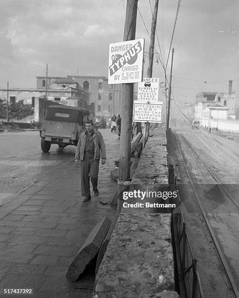 Like every other American soldier in Naples, PFC Paul Zimmer of Oakland, California is only too well aware of the truth of the sign over his head....