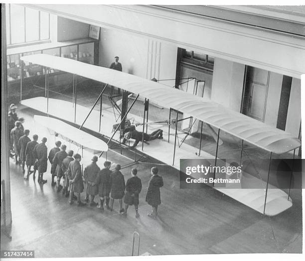 Schoolboys look at the Wright 1903 Flyer during its stay at the London Science Museum because of a disagreement between Orville Wright and the...