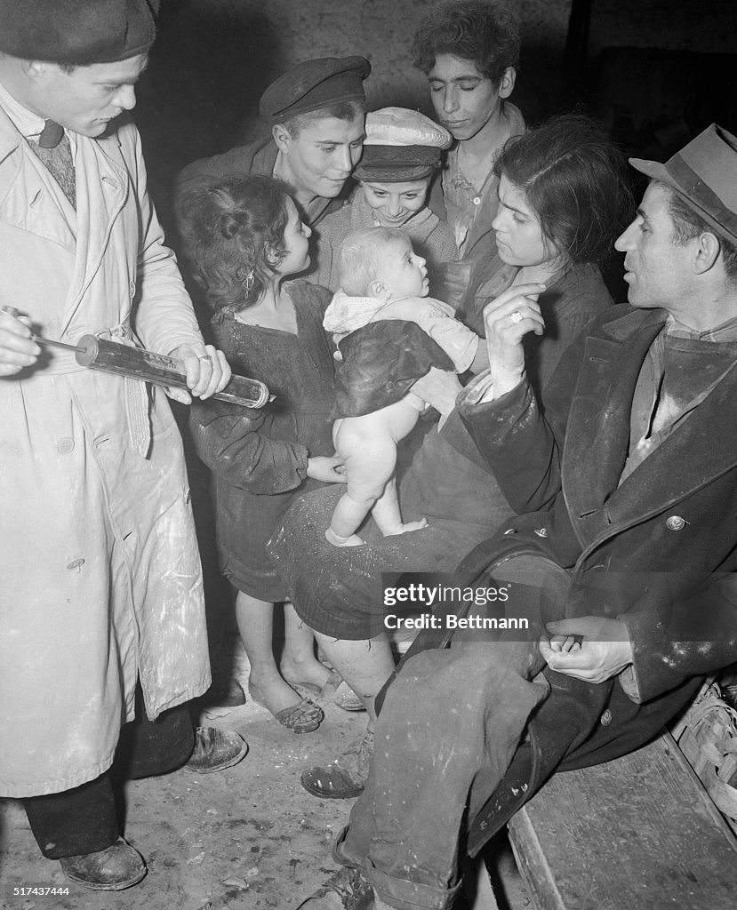 Family Sitting Around Infant of Adoration