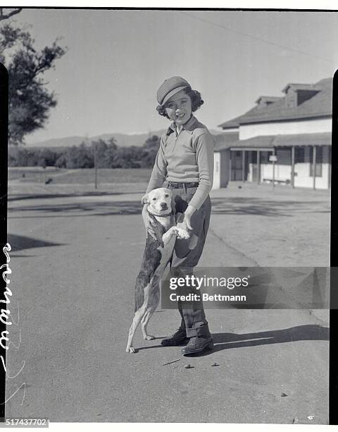 Edith Fellowes, 9 year old film sensation with her pup, "Mickey", at the Riviera Polo Field. Edithe has just scored a hit in She Married Her Boss,...