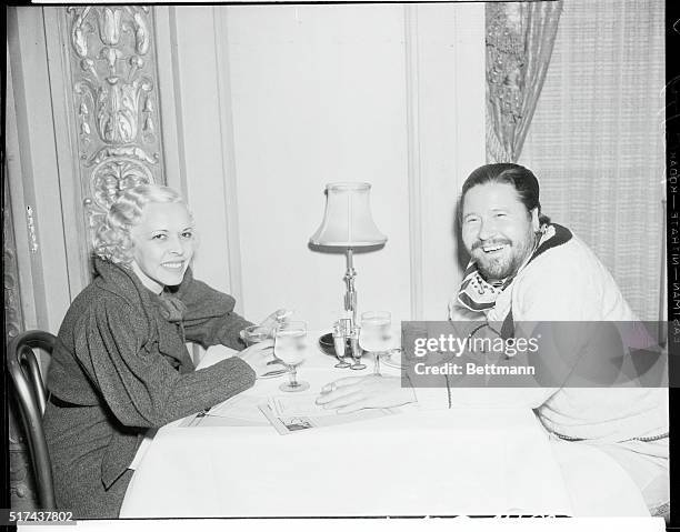 Miss Bobs Hoagland and Jack Oakie at the Beverly Wilshire Hotel. Jack Oakie has a full growth of "Man Mountain Dean or Peter the Hermit" beard as he...