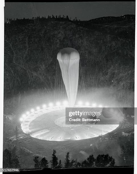 Like a gigantic ghost, the wraith-like-balloon-bag stands out in the darkness, as it was inflated in the great natural bowl outside of Rapid City,...
