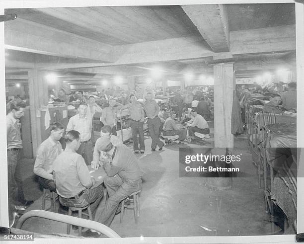 Basement of main Mess Hall used as a Dormitory; one hundred and eighty one men sleep here.
