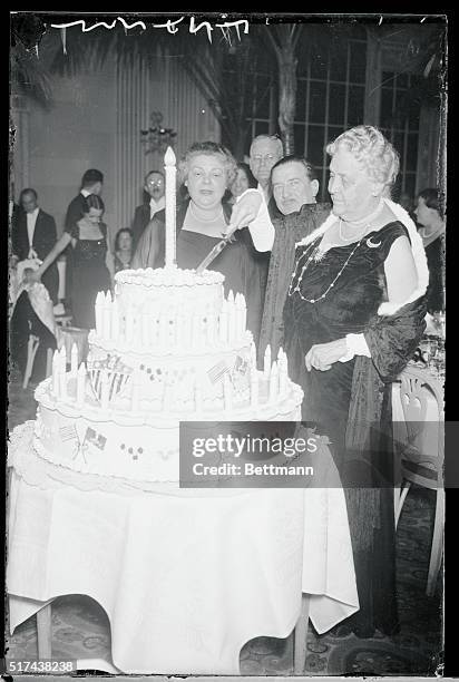 Mrs. James Roosevelt is shown cutting her son's birthday cake at the President's Birthday Ball at the Waldorf Astoria of New York City.