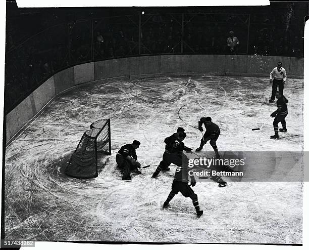 Bill Moe , of the Rangers, falls flat on the ice and the puck to break up a first period scoring attempt by a trio of Canadiens. Maurice Richard ,...
