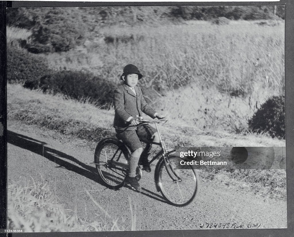 Crown Prince Akihito Riding Bicycle on Palace Grounds