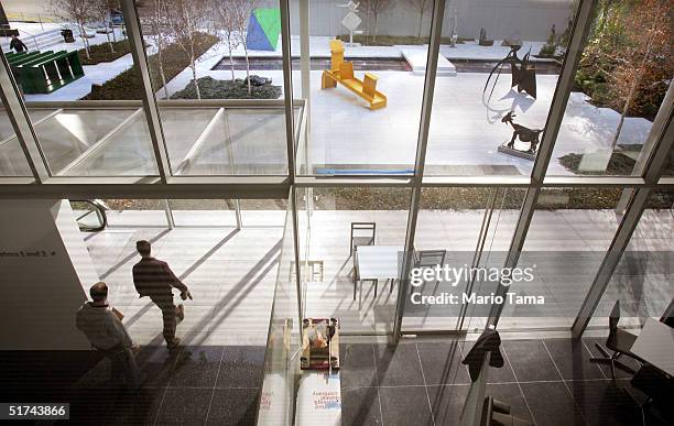 Worker carries a drill in front of the Sculpture Garden in the newly remodeled Museum of Modern Art during a media preview November 15, 2004 in New...