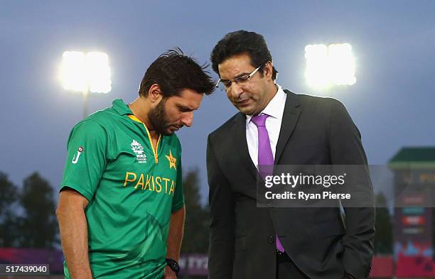Shahid Afridi, Captain of Pakistan speaks with former Pakistan cricketer Wasim Akram during the ICC WT20 India Group 2 match between Pakistan and...