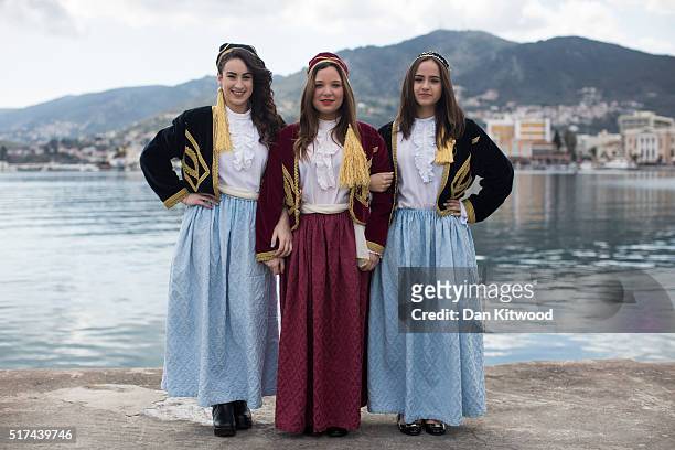School children wearing traditional island dress pose as they wait for the Independence Day parade on March 25, 2016 in Mytilene, Greece. The annual...