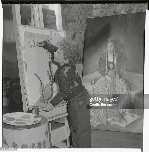 Norman "Skippy" Miller who has had four exhibitions of his paintings, is shown here working in his home on one of his creations. The son of Edgar and...