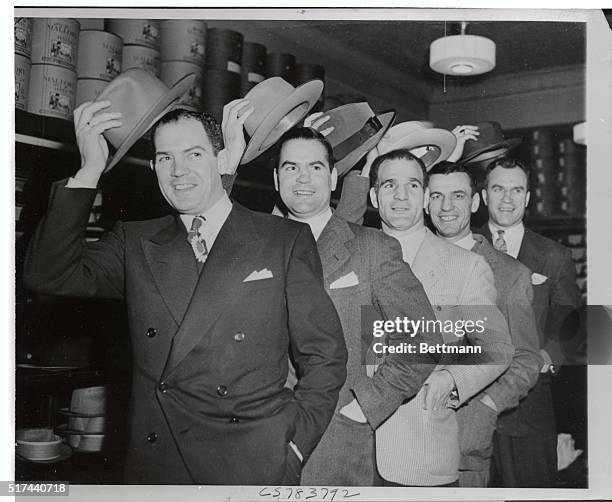 Chicago Black Hawks goal tender Mike Karakas and the Hawks' four defense men with new hats purchased with the $50 reward Mike received for holding...