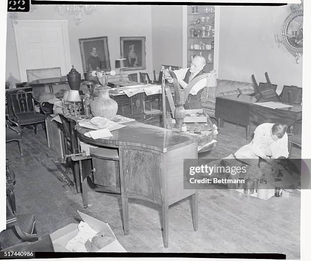 Painter holds a roll of wall paper which will be hung in reception room of Gracie Mansion, now being redecorated for occupancy by the new mayor and...