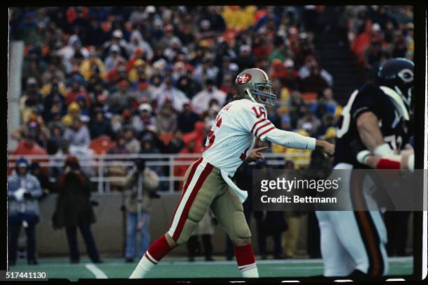 San Francisco 49ers' quarterback Joe Montana is shown having just thrown the football in a game against the Chicago Bears.