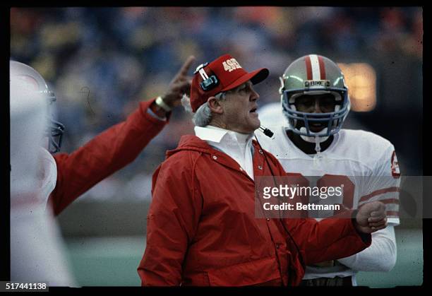 San Francisco 49ers' Coach Bill Walsh is shown talking to a member of his team during a game against the Chicago Bears.