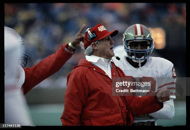 San Francisco 49ers' Coach Bill Walsh is shown talking to a member of his team during a game against the Chicago Bears.
