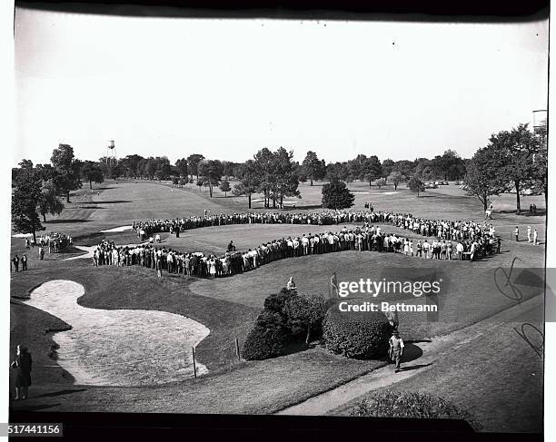 Crowds gather around the ninth green to witness putting in the international match play at Winged Foot golf course, Mamaroneck, New York, on...