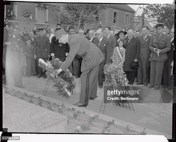 General Charles De Gaulle lays a wreath on the monument to the dead at Courseulles, near Bayeux, France. The former President of France made a speech...