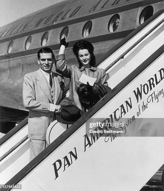 Laurence Olivier and his wife Vivien Leigh, British stage and screen stars, board a Pan American Constellation at LaGuardia Field, June 18. Shortly...