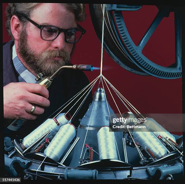 Space Shuttle protection, Nextel ceramic fiber being braided into sleeving, is flexible insulation around doors and hatches to protect against the...