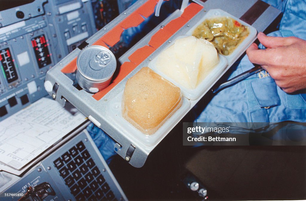 Astronaut with Tray of Columbia Food