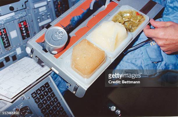Johnson Space Center, Houston - Earth Orbit: The evening meal for STS-9 Day Four is partially visible in the 35mm frame, photographed on the flight...
