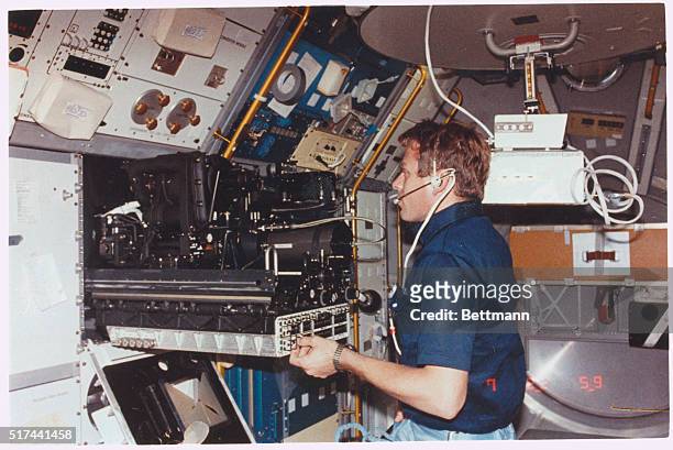 Johnson Space Center, Houston - Earth orbit: Byron K. Lichtenberg carries out an experiment at the fluid physics module on the busy materials science...
