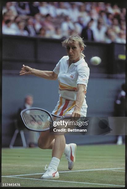 Tennis champion Martina Navratilova preparing to hit the ball with a backhand swing during the Wimbledon Women's Singles Finals.