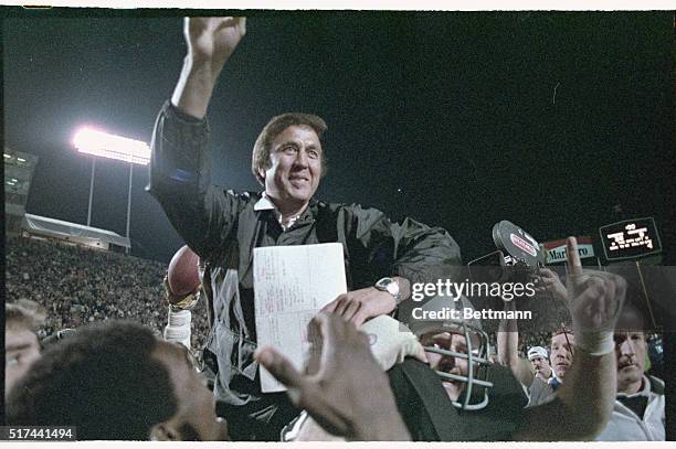 Los Angeles Raiders' coach, Tom Flores, is carried off the field of Super Bowl XVIII by his team after they defeated the Washington Redskins.