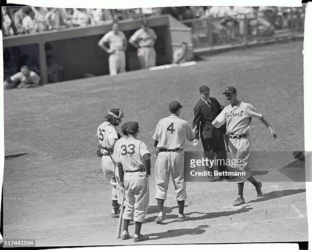 Completing his third inning homer, Detroit's Hank Greenberg crosses the plate and is congratulated by teammate Dick Wakefield, during the Detroit...