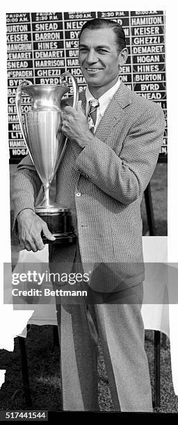 Ben Hogan holds the trophy after scoring a triumph in the $10,000 Goodall Round Robin Tournament over the West Course at Winged Foot Club,...