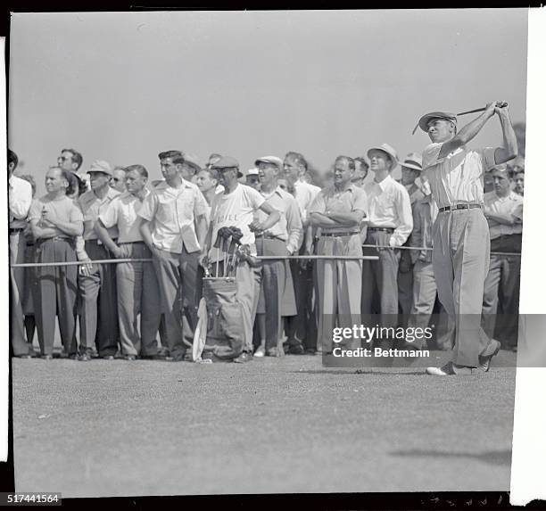 Ben Hogan playing an approach iron shot to the green on the first hole, went on to card a one over par 73 to retain in the lead at the end of two...