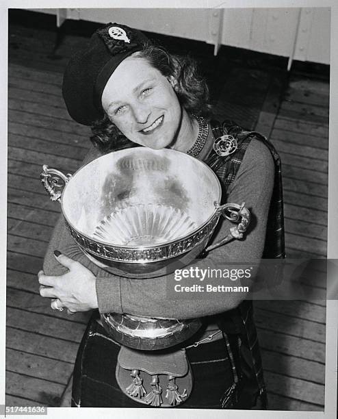 First American golfer to win the British Women's Amateur Golfer to win the British Women's Amateur Golf Championship, Babe Didrikson Zaharias hugs...